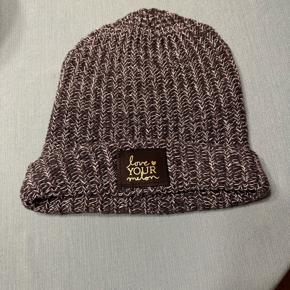 Charcoal & white cuffed Love Your Melon beanie with black gold foil patch.